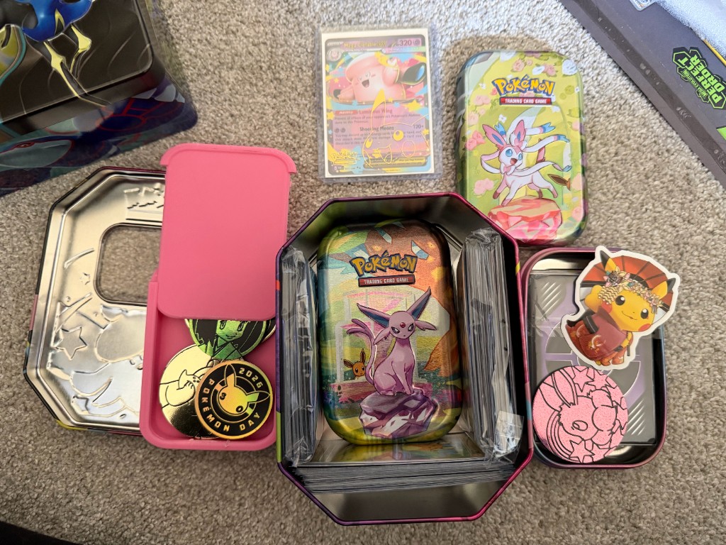 Octagon collector tin with nested tins, coins, stickers, and sleeved cards